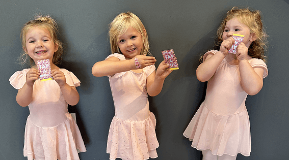 Young Discover dancers in pink leotards holding class awards