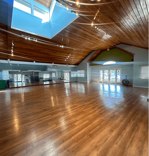 Inside the studio with vaulted wood ceilings and ballet barres